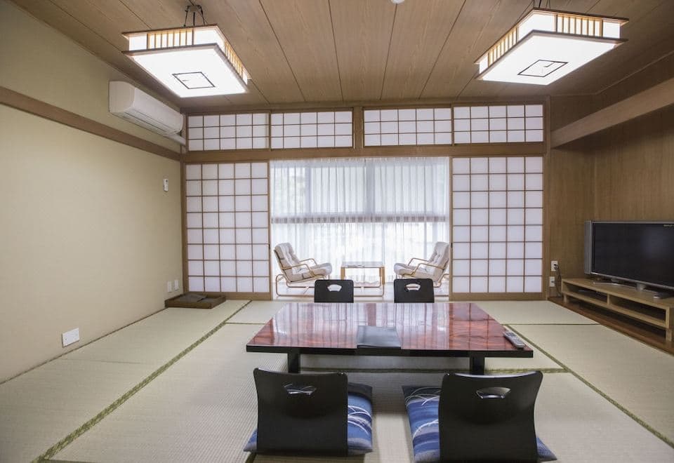 Atami Shogetsu standard tatami guest room with shoji screens, floor chairs and television