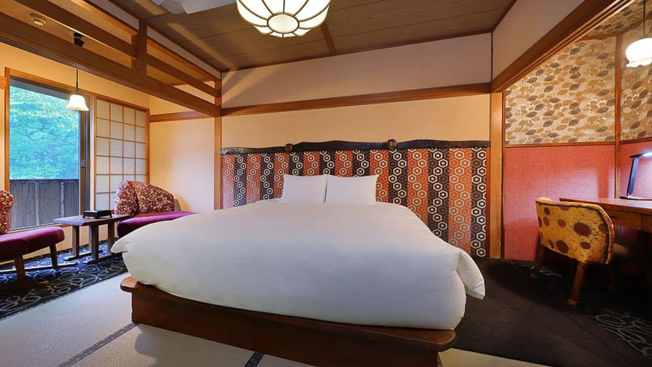 Guest room with a Western bed and patterned Japanese decor