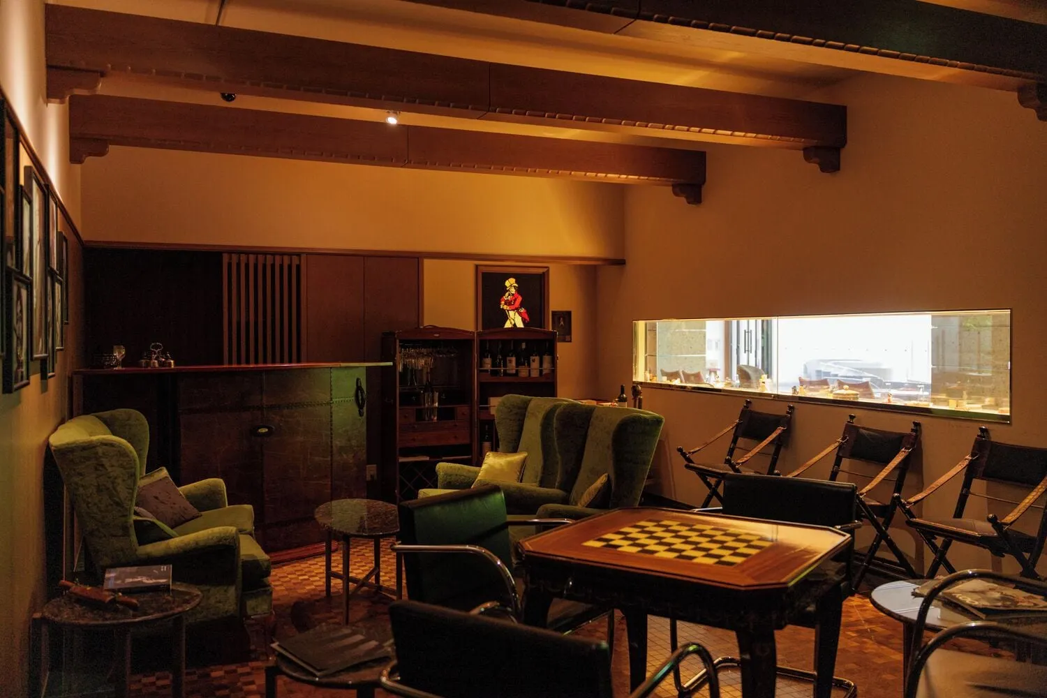 Lounge with leather chairs and a fireplace facing the mountains