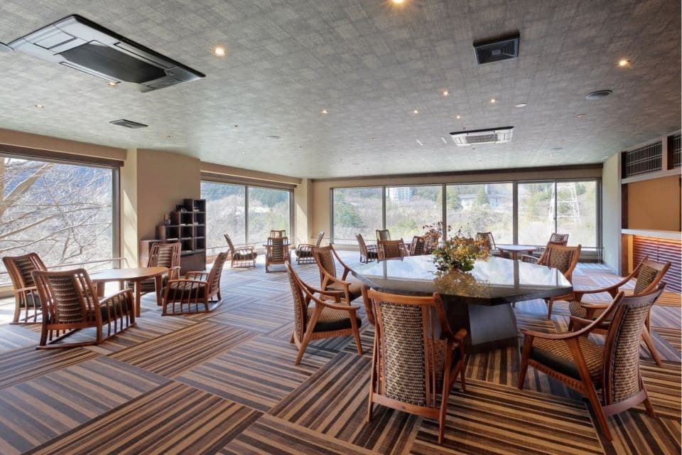 Lounge area with large windows facing the valley