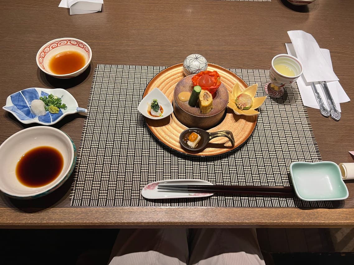 Kaiseki appetizer course arranged on a bronze plate
