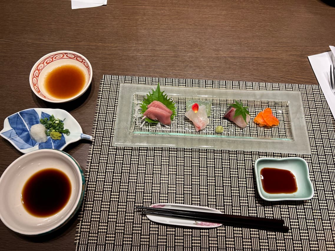 Kaiseki sashimi course plated on a glass dish