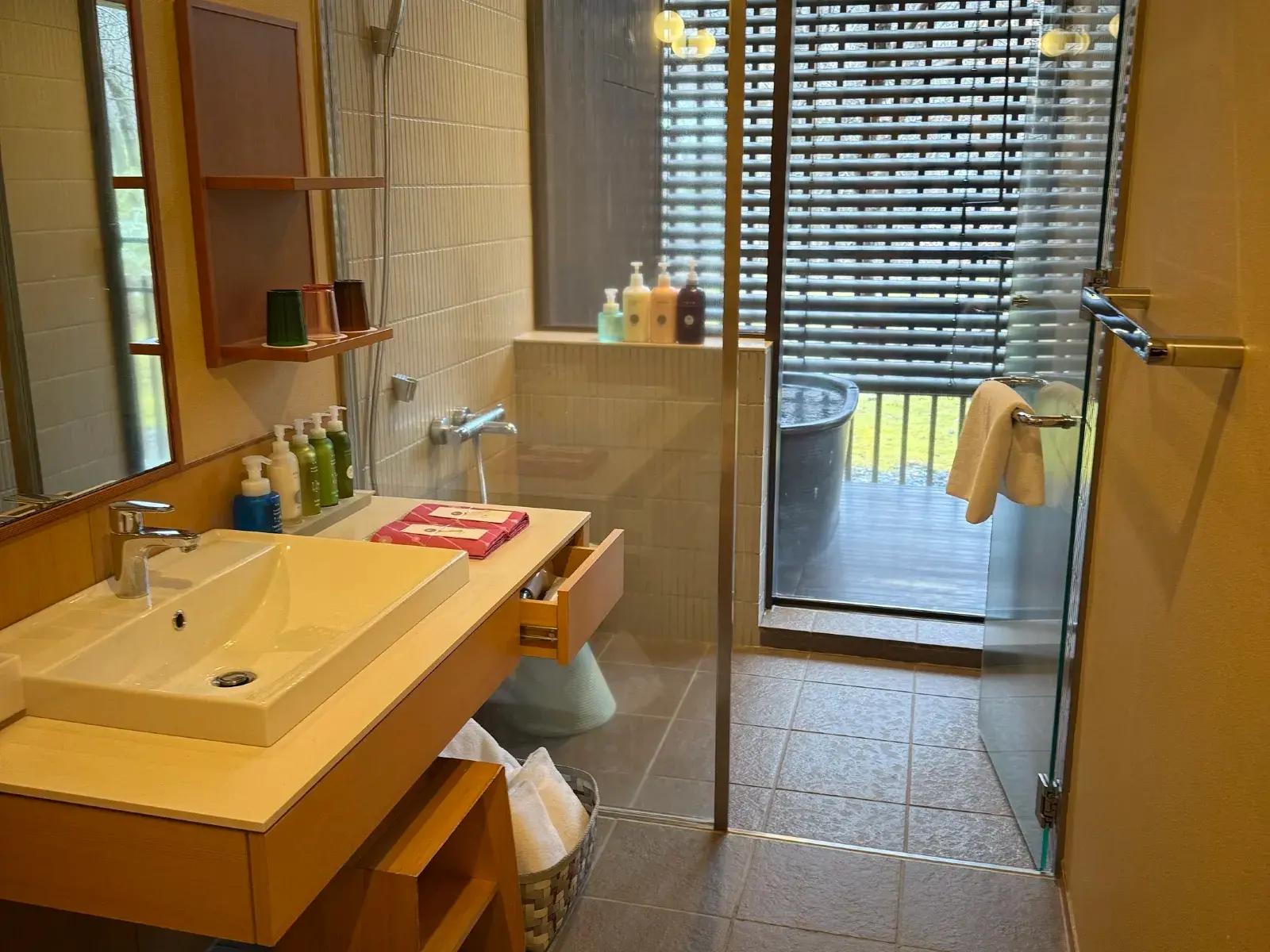 Indoor communal bath with cherry blossoms visible through the glass wall