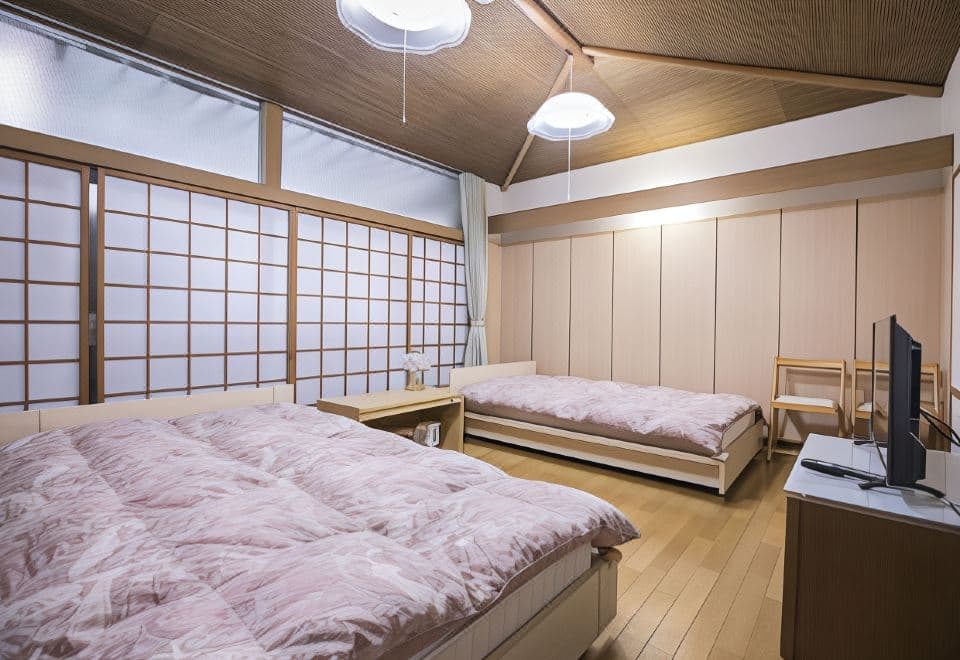 Atami Shogetsu Japanese-style room with futon beds on raised floor and shoji sliding windows