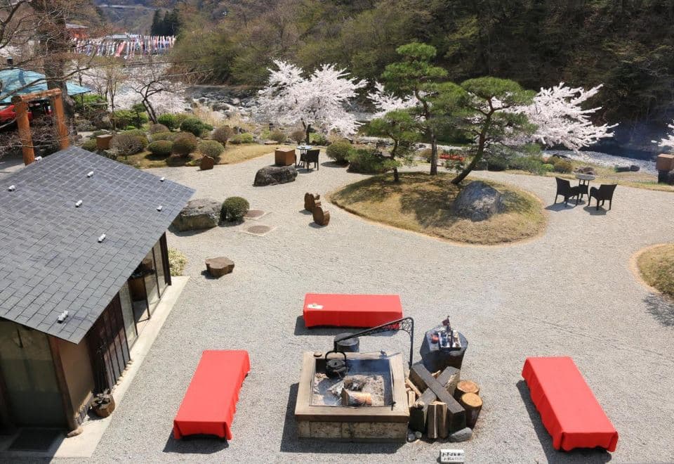 Tatami guest room with a futon, low wooden table and armchair