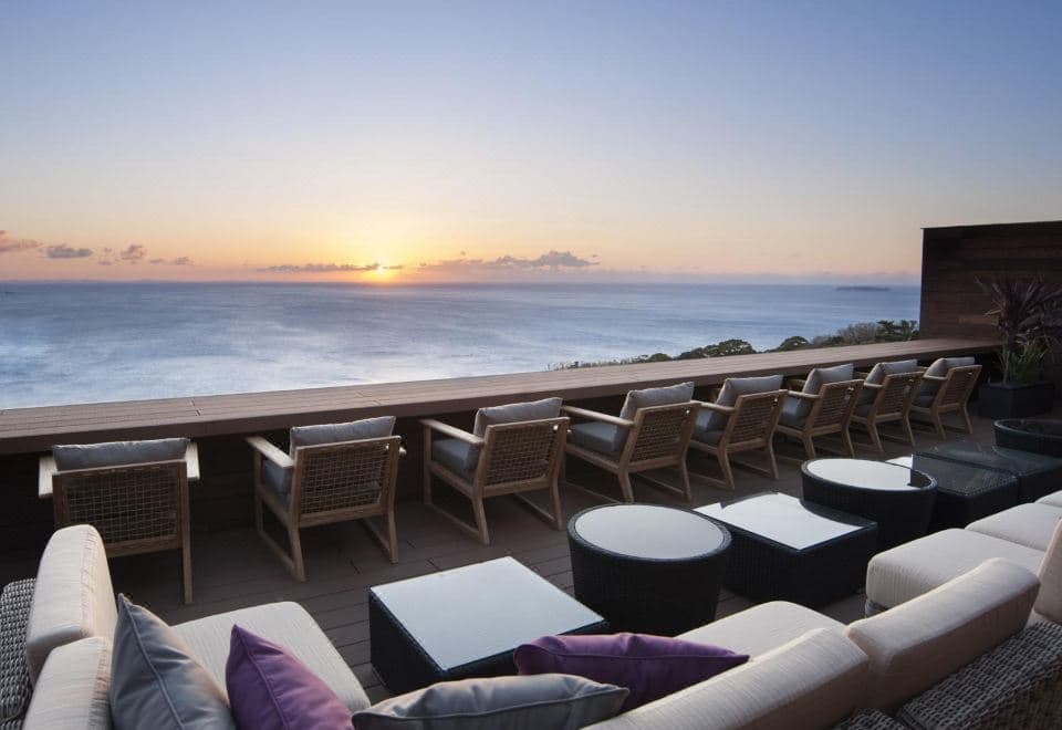 Atami Sekaie rooftop terrace at sunset with Sagami Bay and Hatsushima Island on the horizon