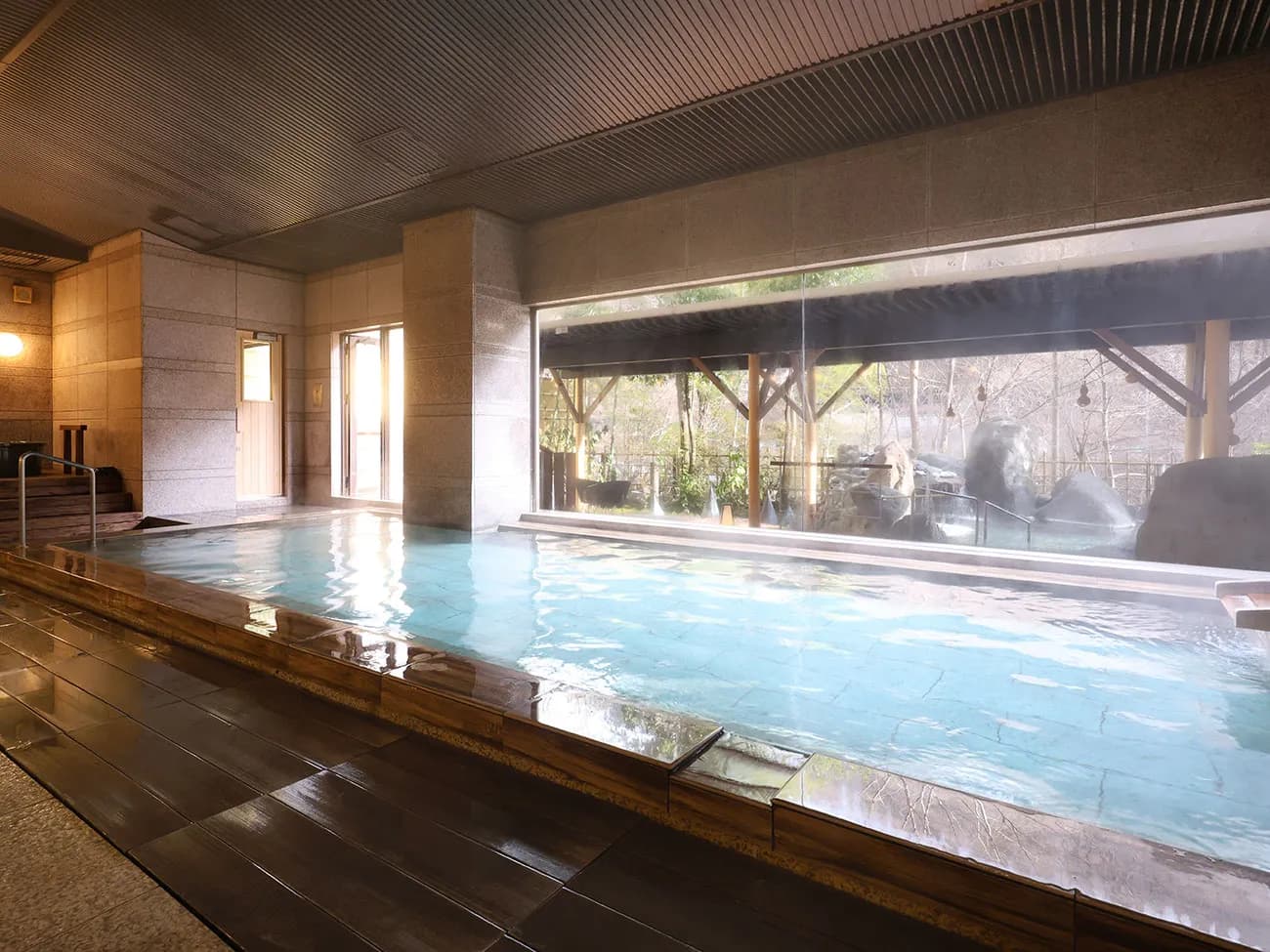 Indoor bath with a rock garden view