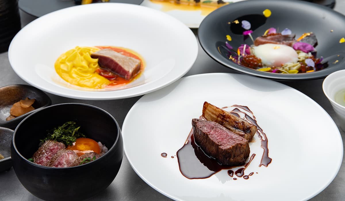 Multi-course wagyu beef kaiseki dinner plated on white and black dishes at Bettei Amafuru Oka in Ibusuki