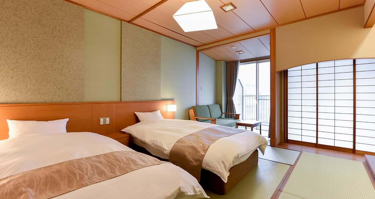 Twin-bed Japanese-Western guest room at Oku no Hosomichi with tatami corner and shoji-screened window