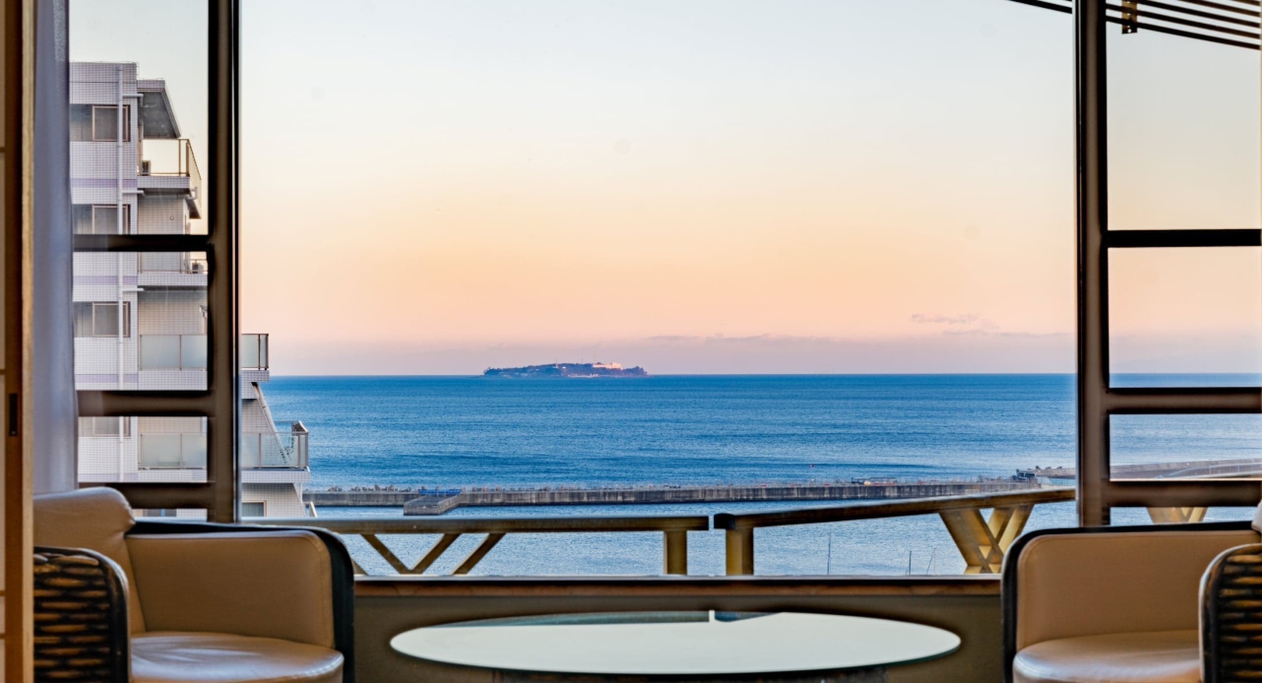 Sunset sea view of the bay seen from a guest room balcony at Hotel Kanichi