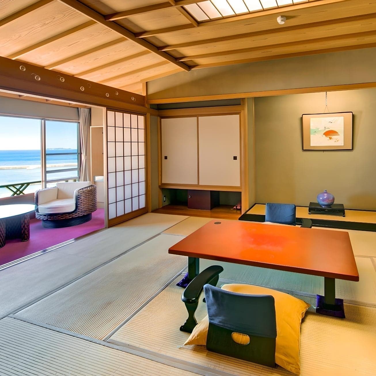 Tatami guest room with low table and ocean view at Hotel Kanichi in Atami