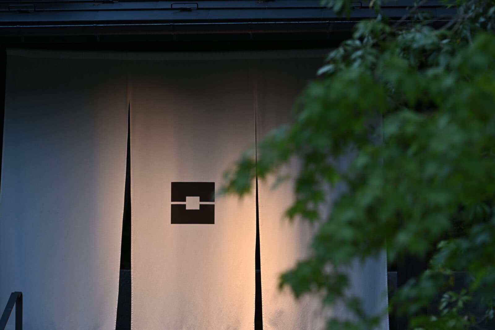 Lantern-lit lattice entrance doors above dark stone steps