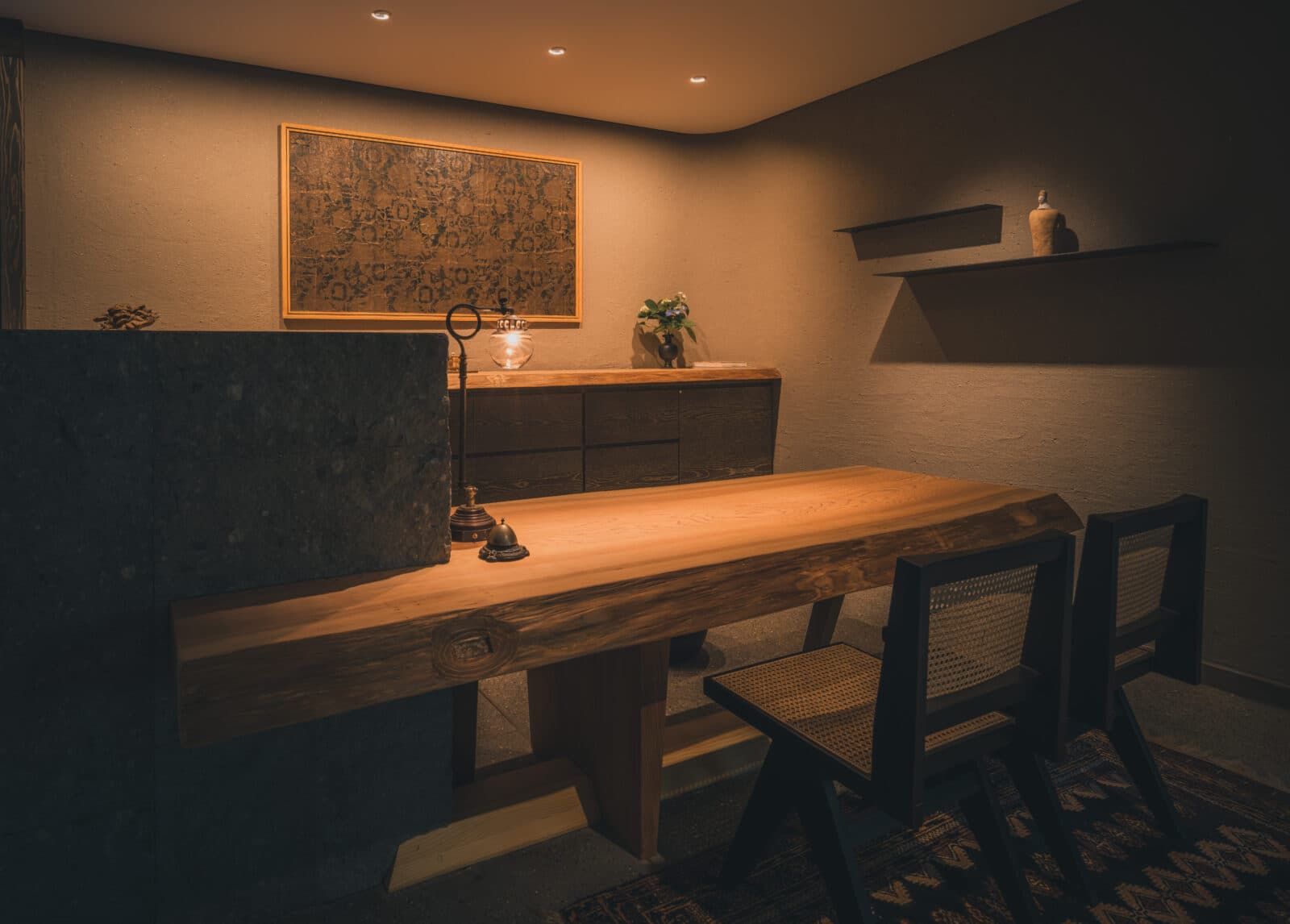 Reception lounge with a live-edge wooden table and framed artwork