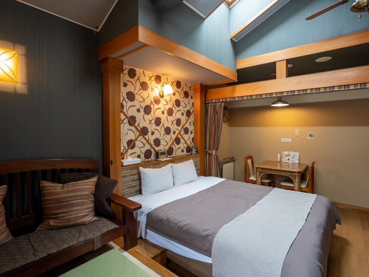 Loft-style guest room with skylight and sitting sofa