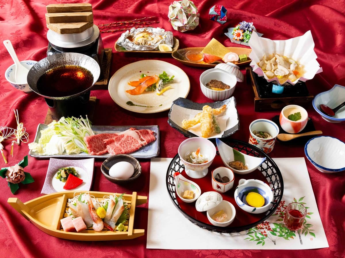 Multi-course kaiseki dinner spread with sashimi boat, wagyu and small dishes at Zenshichinoyu Ohira, Zao Onsen