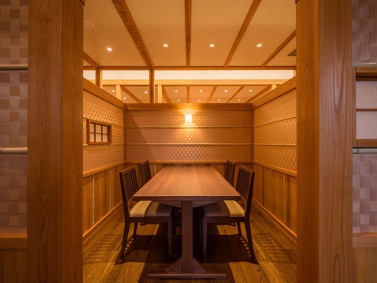 Private dining room finished in warm cedar and bamboo with a long wooden table, Yumoto Kissho, Naruko Onsen