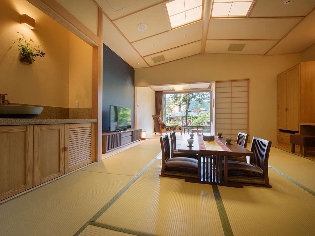 Spacious tatami guest room with low dining table, washbasin and garden-view terrace, Yumoto Kissho, Naruko Onsen