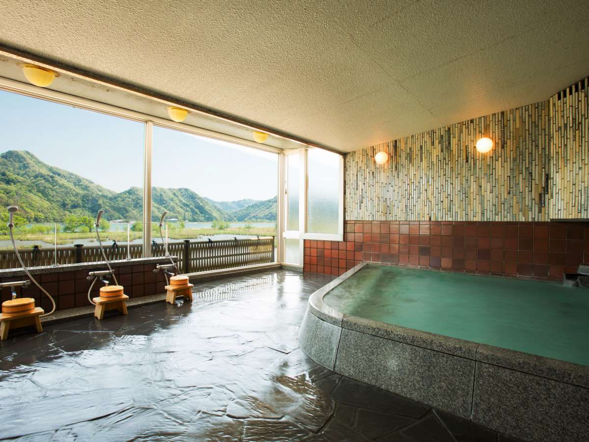 Indoor hot-spring bath at Oyado Seri with warm wood interior