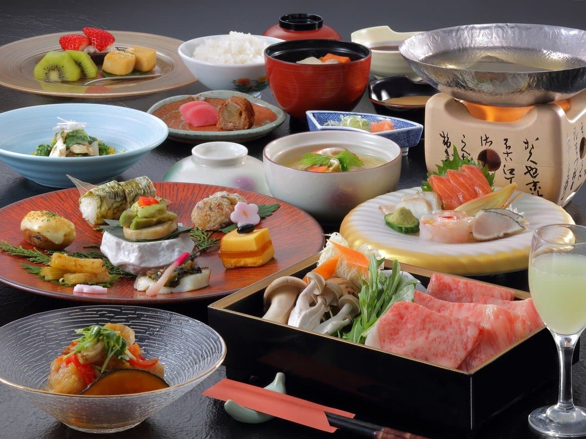 Multi-course Japanese kaiseki dinner spread featuring Yamagata wagyu beef shabu-shabu and sashimi