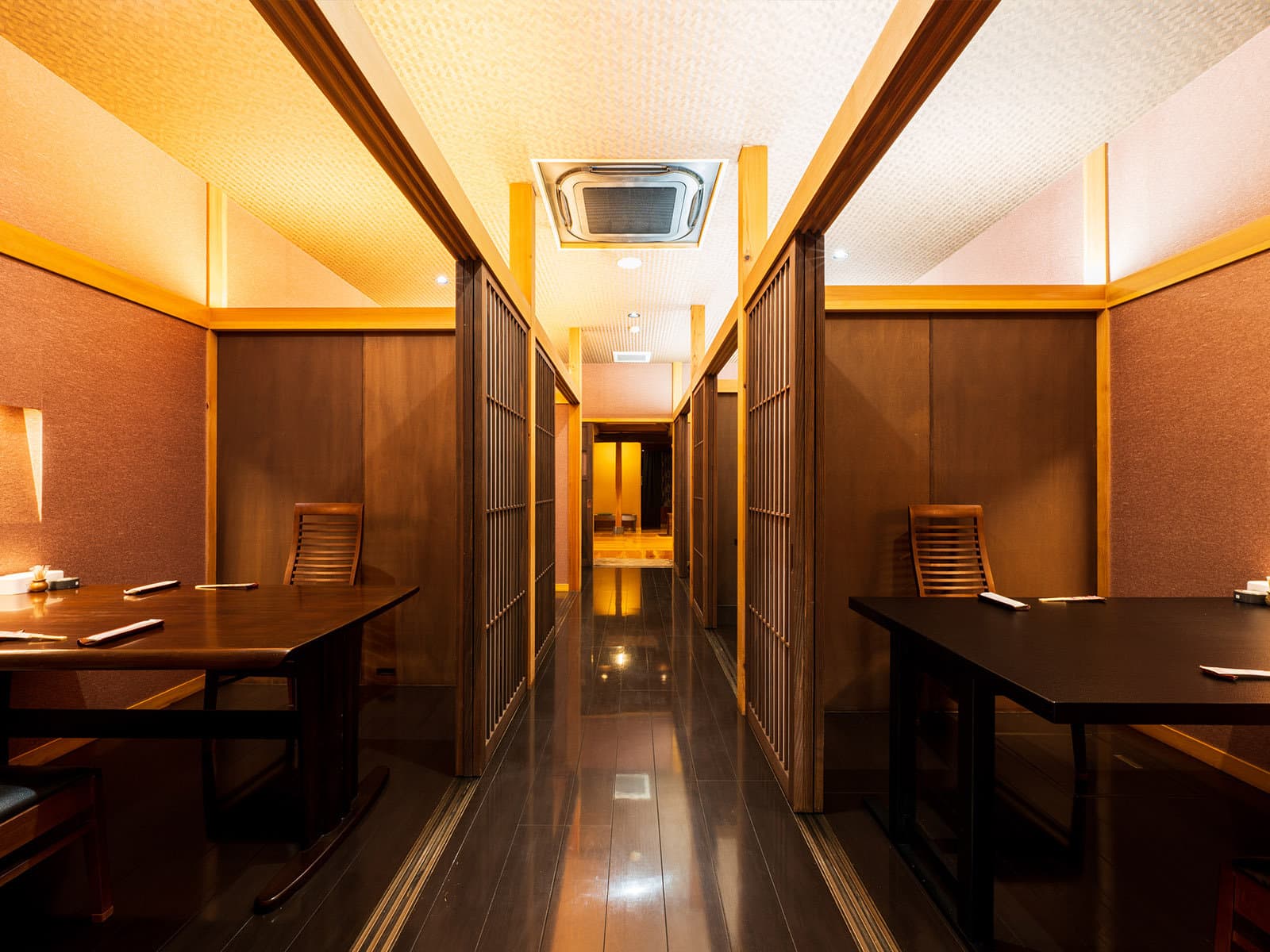 Warm wooden dining corridor with private booths inside Hozantei