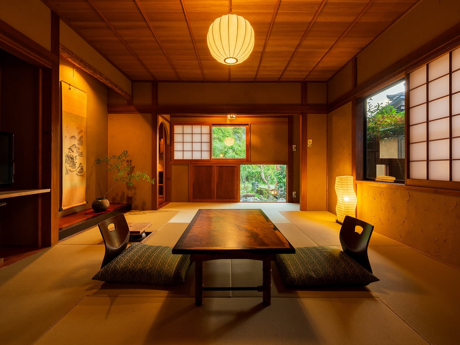 Tatami lounge at Hozantei with table and chairs beside a garden-view window