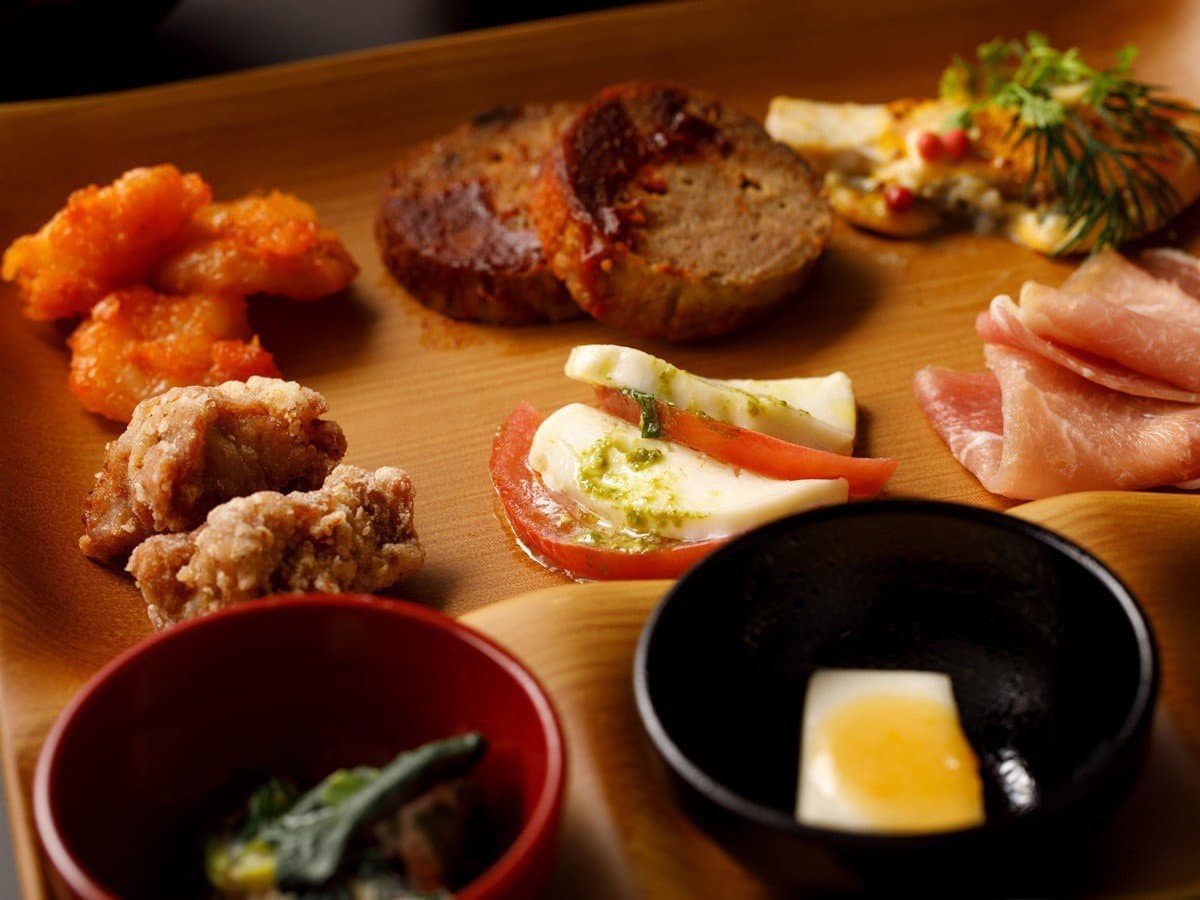 Yusai plated kaiseki appetizer course with hamburg steak, karaage and caprese on wooden tray