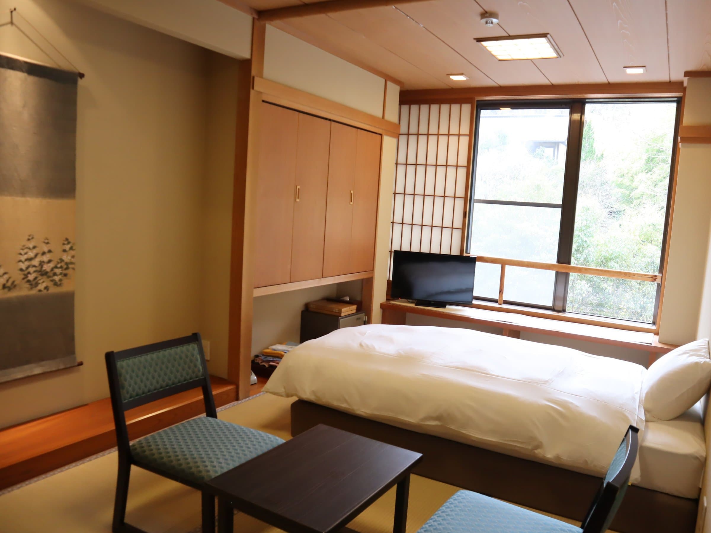 Yusai Japanese-Western guest room with twin beds, shoji screens and bamboo-grove view