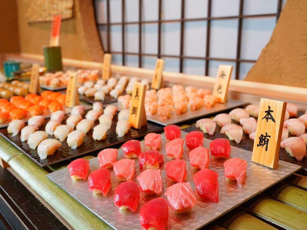 Yusai dinner buffet display of fresh nigiri sushi including bluefin tuna on bamboo counter