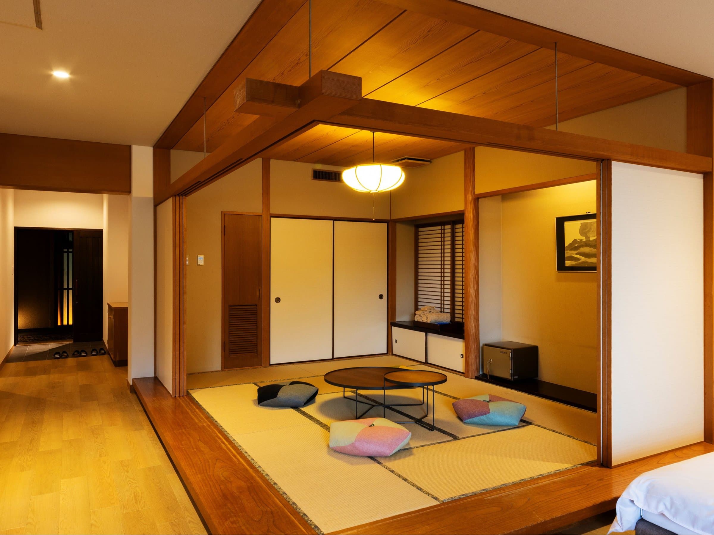 Yusai spacious premium room with raised tatami area, low table and warm wood interior