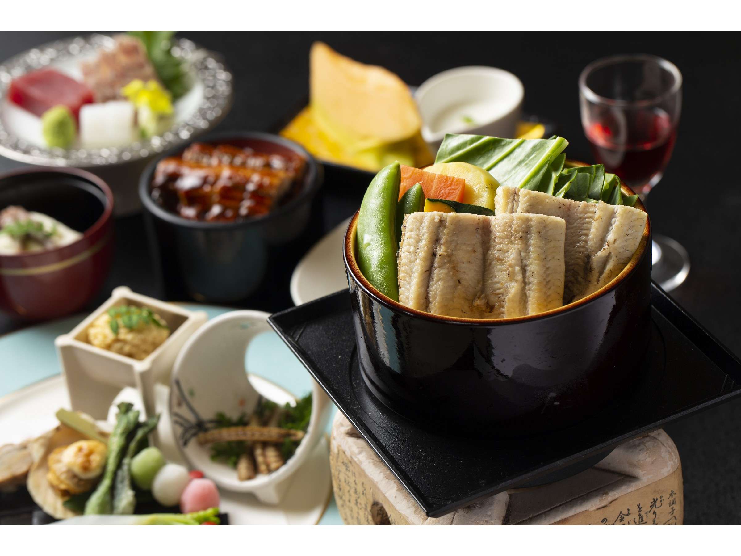 Kaiseki dinner spread at Ibusuki Phoenix Hotel featuring grilled eel, sashimi, simmered dishes and wine