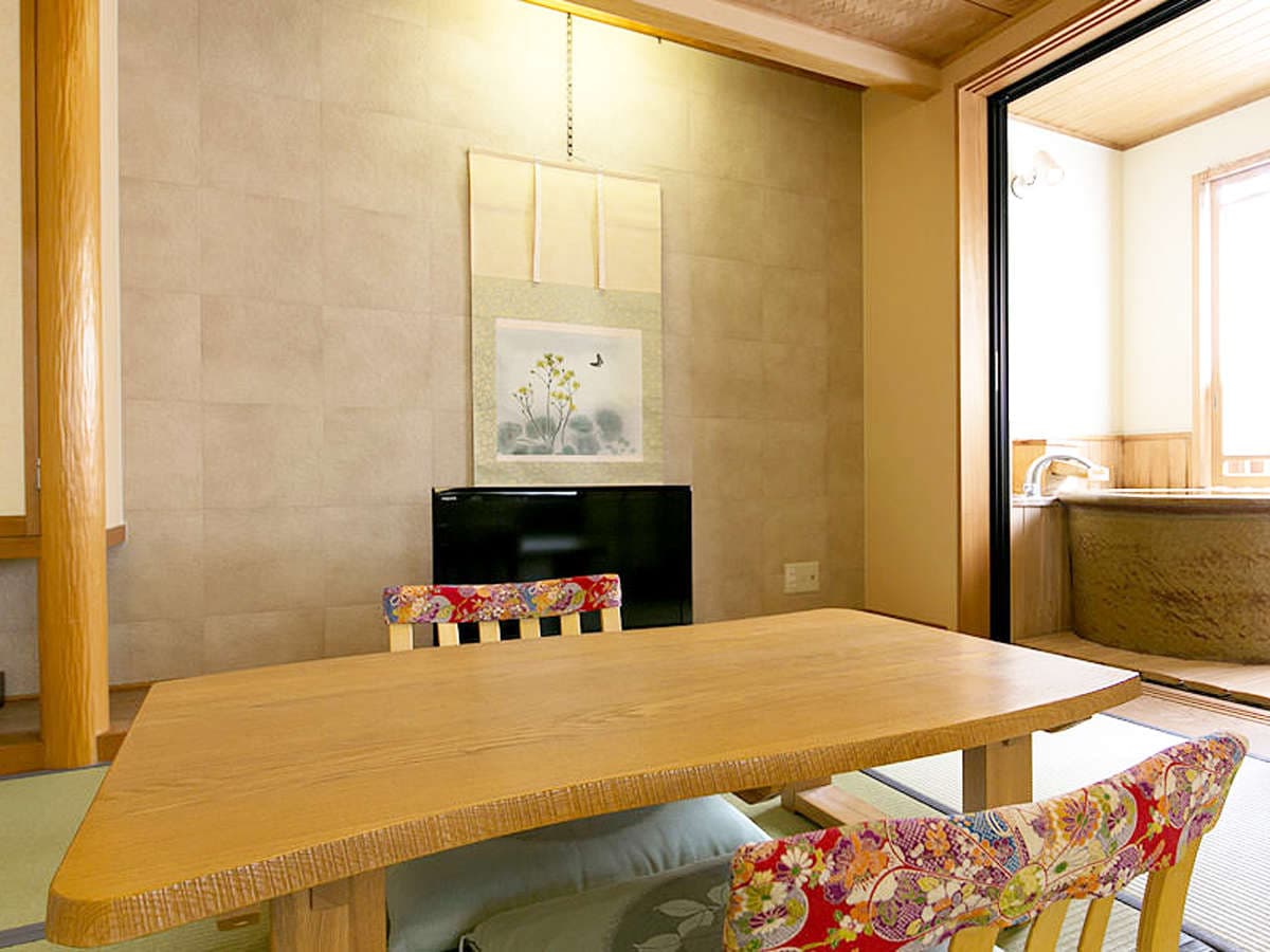 Japanese-style guest room at Hakuba Hifumi with low wooden table, tokonoma alcove and adjoining cypress bath