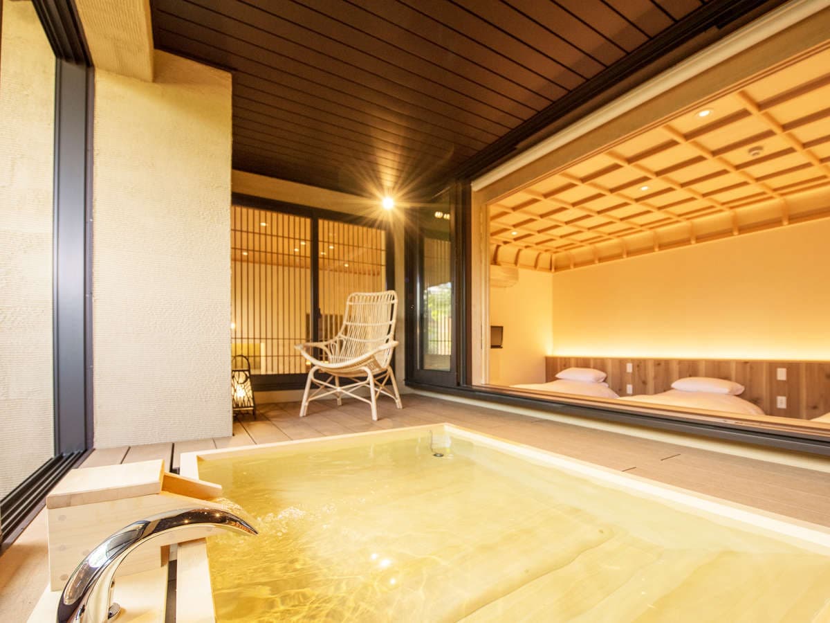 Modern guest room at Hakuba Hifumi with twin beds and a private indoor hinoki soaking tub