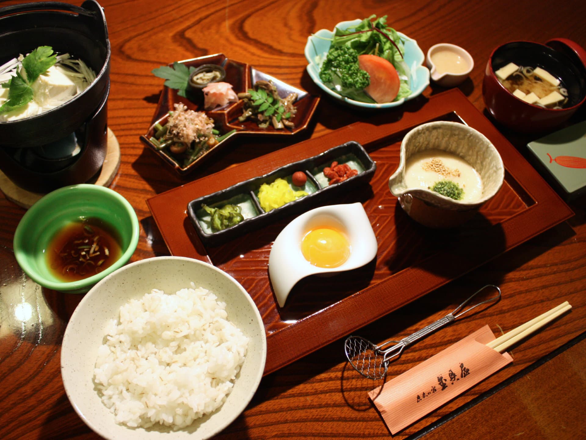 Japanese breakfast set with barley rice, grated yam, raw egg and miso soup