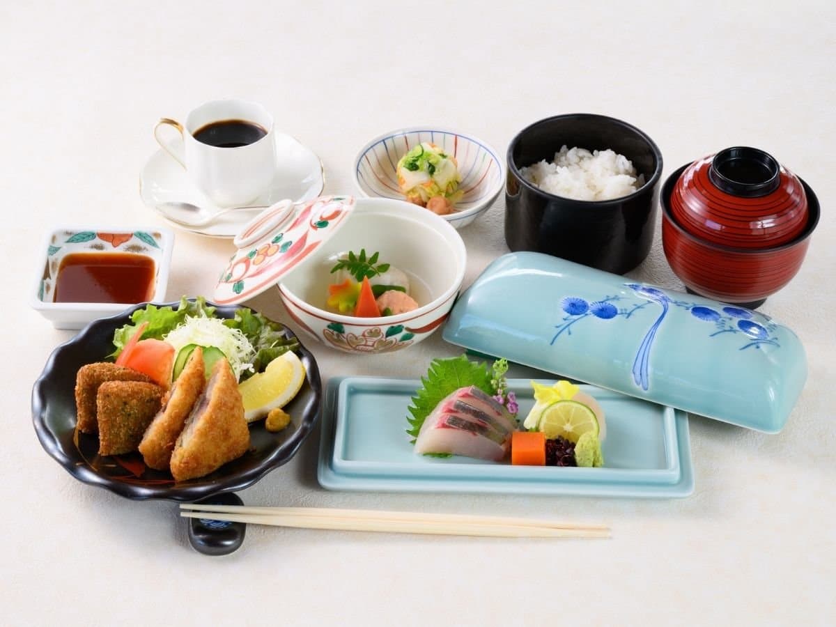 Japanese breakfast set with rice, miso soup, grilled fish and sashimi