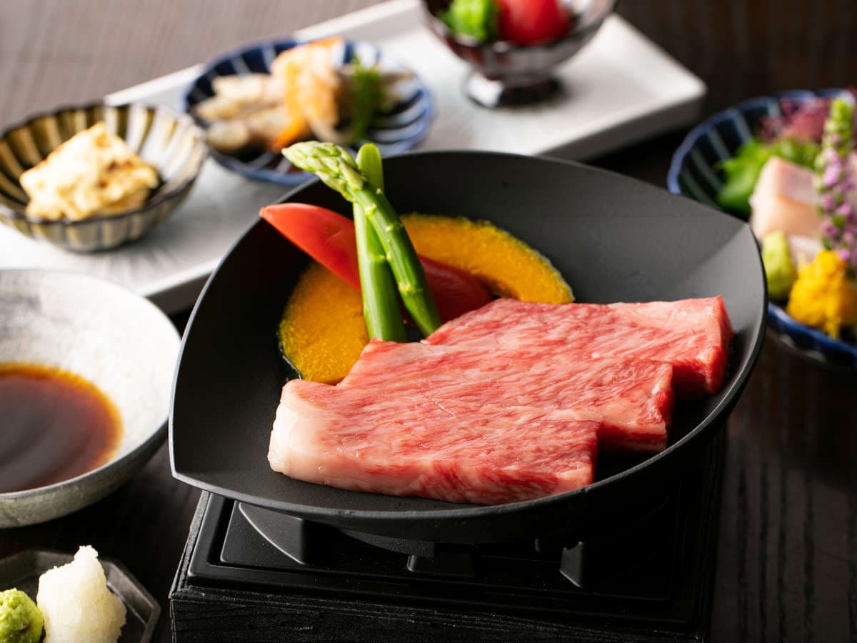 Hida wagyu beef kaiseki dinner spread with grilled steak, seasonal vegetables and small side dishes