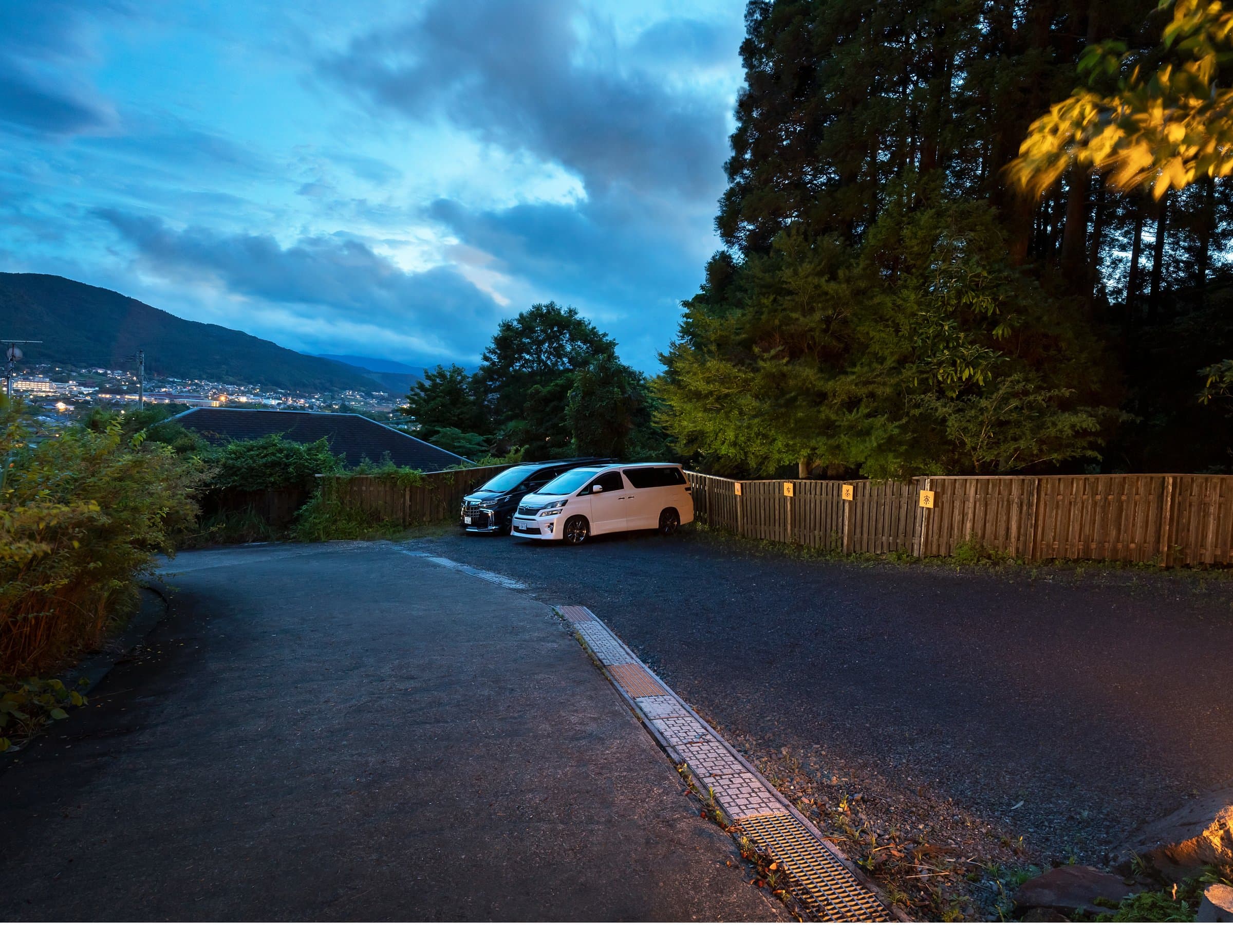 Mountain road winding through the green hills of Yufuin near Yufuin Yufusaryo at dusk