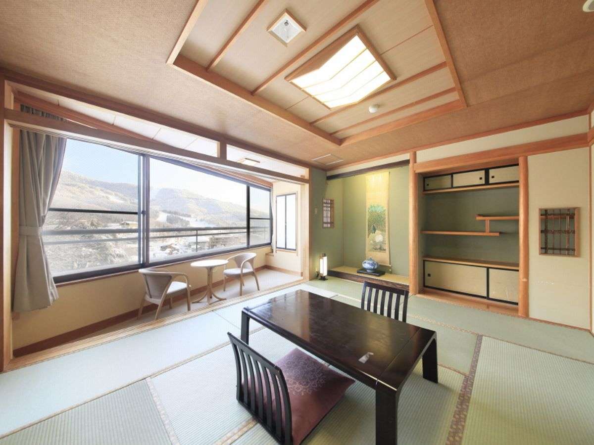 Japanese-style tatami guest room with tokonoma alcove and mountain view at Zao Plaza Hotel