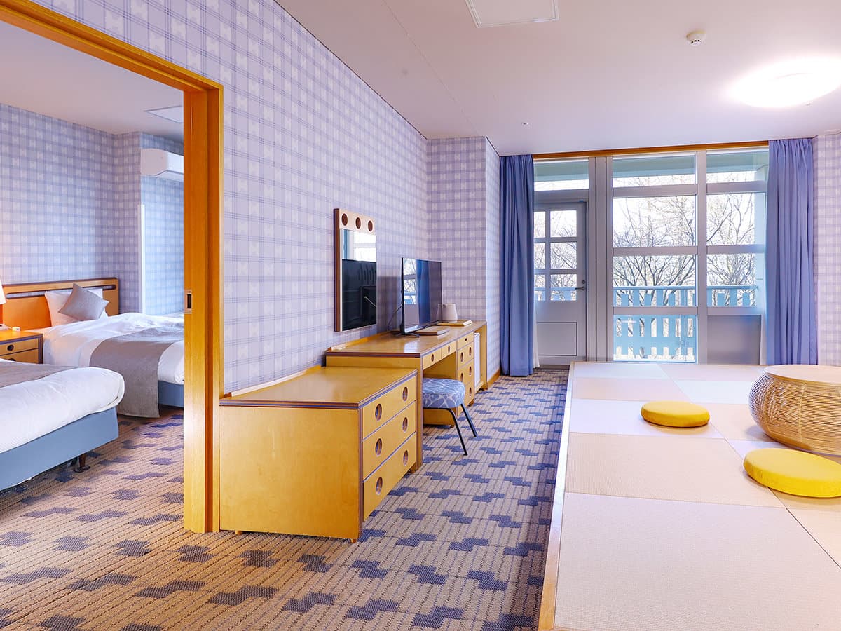 Suite combining a western bedroom and a tatami area with garden-facing windows at TAOYA Nikko Kirifuri