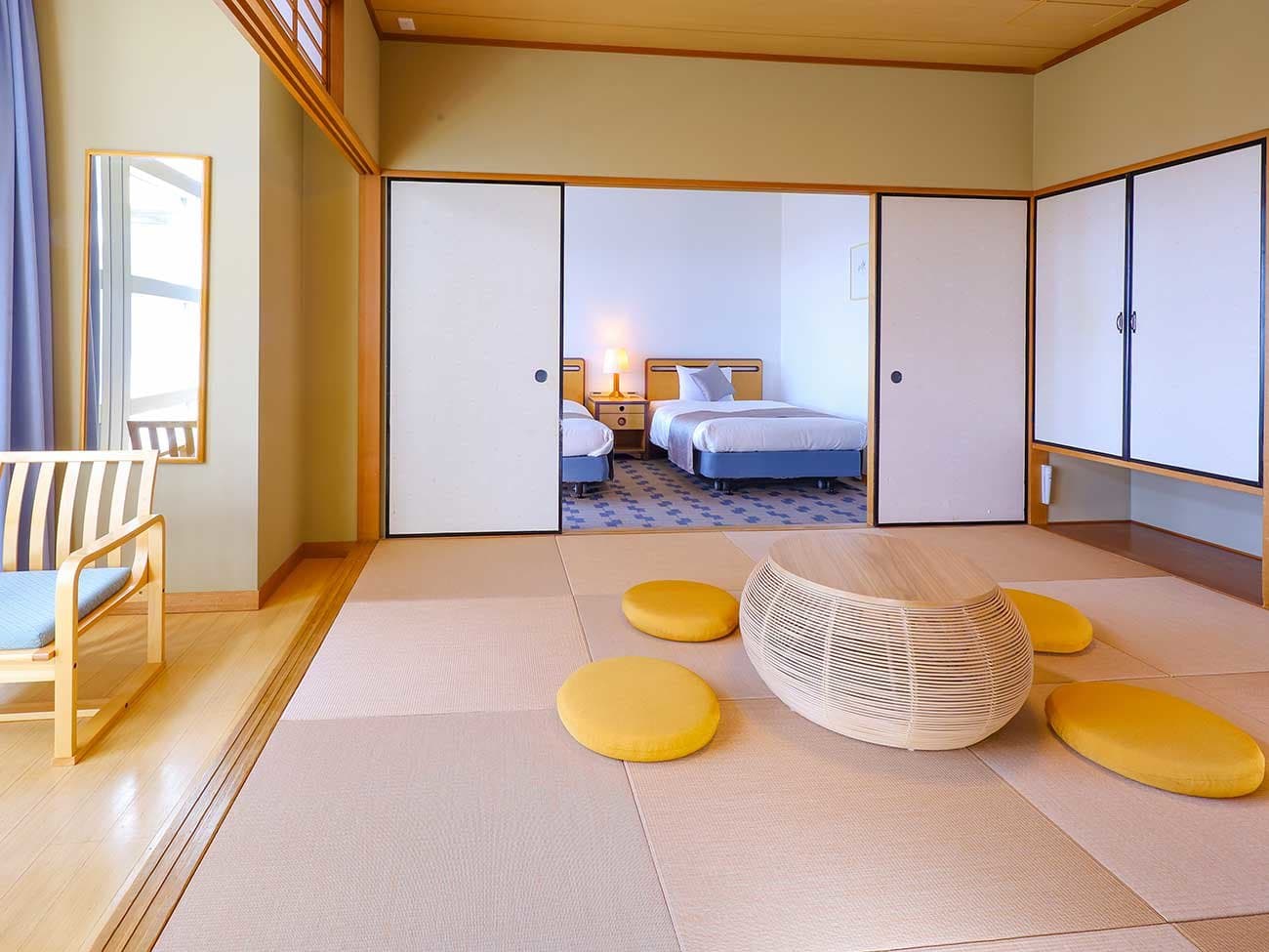 Spacious tatami guest room with twin beds in an adjoining western alcove at TAOYA Nikko Kirifuri