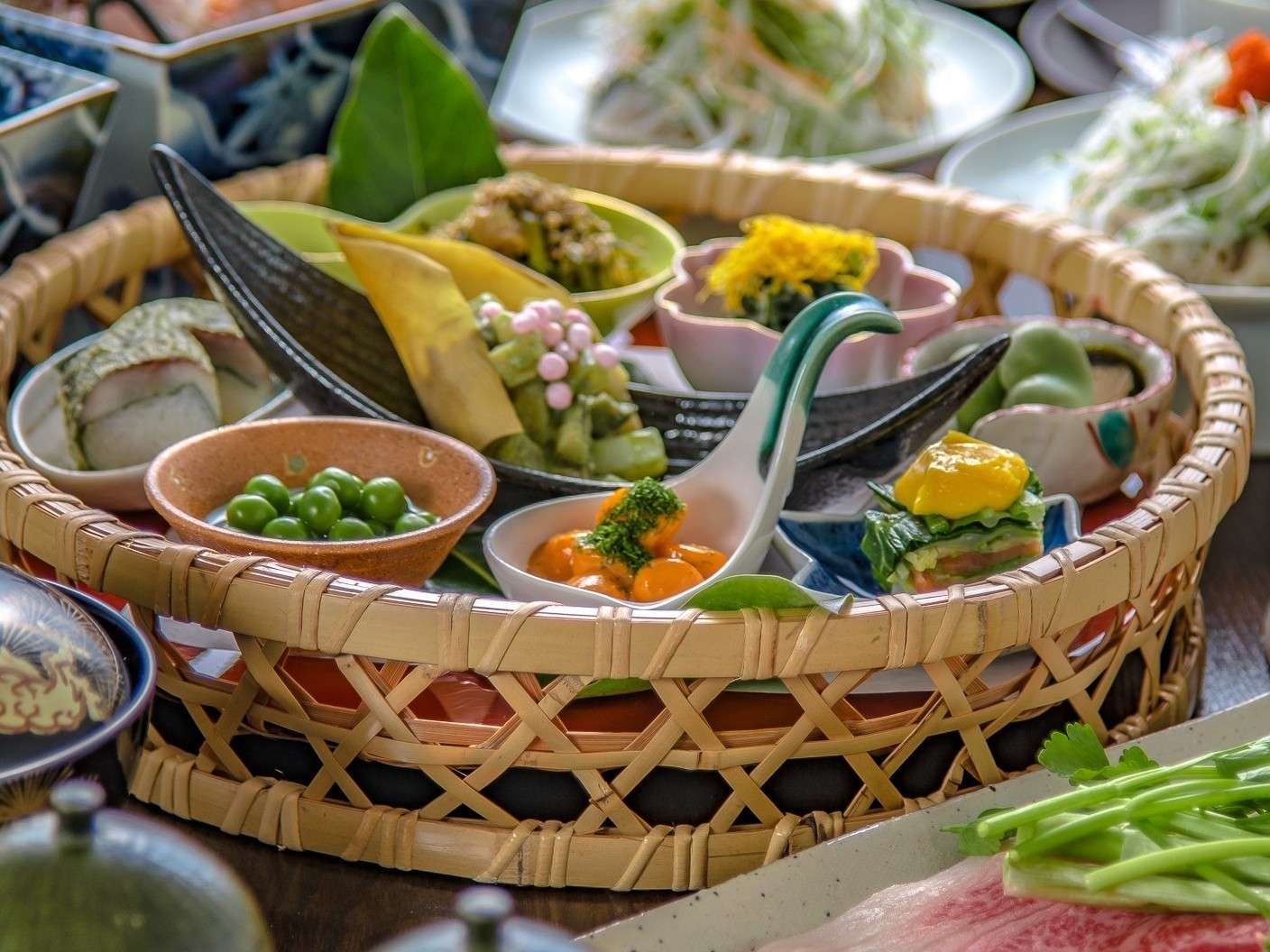 Woven bamboo basket of seasonal kaiseki appetizers served at Yuhri ryokan