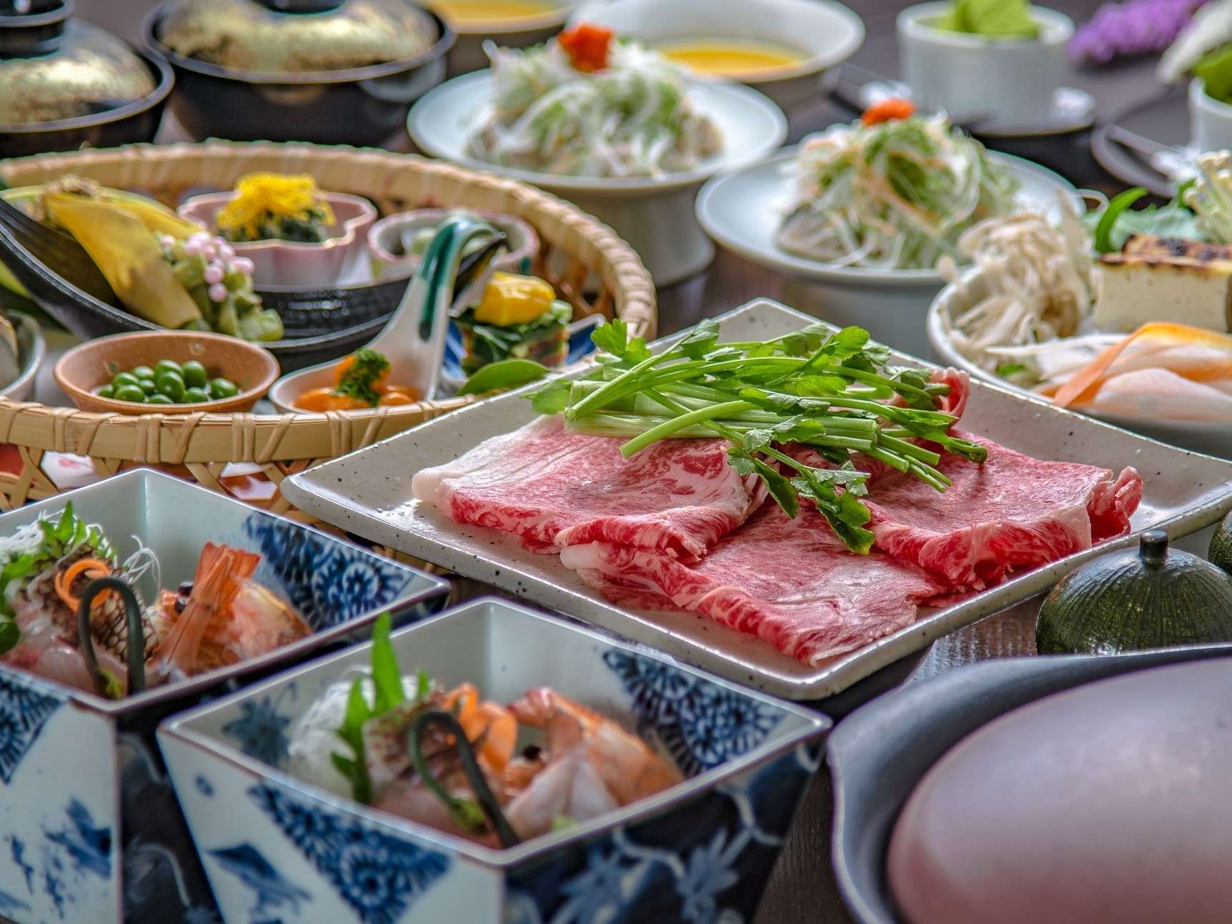 Kaiseki dinner spread featuring marbled Bungo wagyu beef and seasonal small dishes