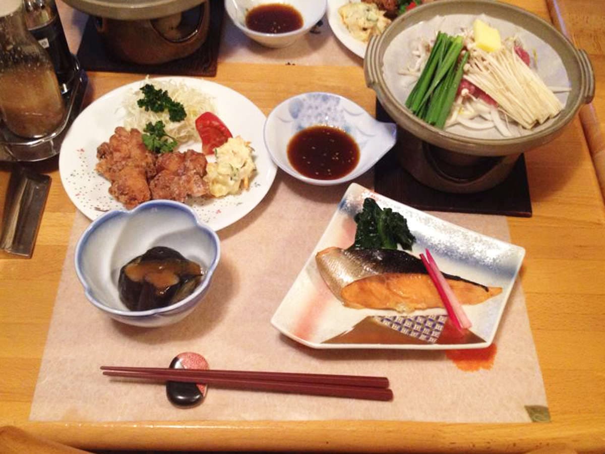 Japanese dinner set at Ryokan Furuya with a small hot pot, grilled fish, fried chicken and side dishes