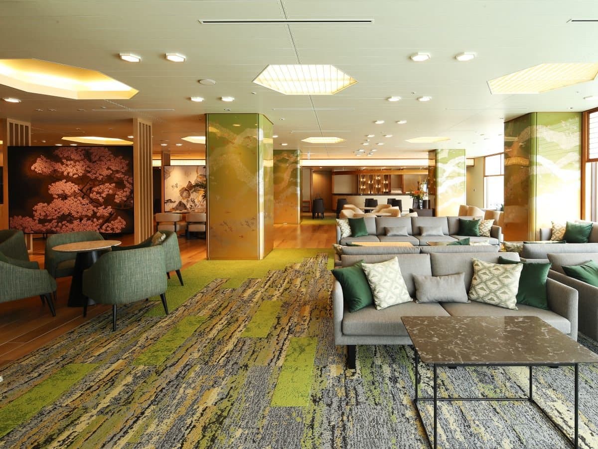 Sakura Lounge at Hotel Sakurai with grey sofas, green carpeting and gold-leaf art panels