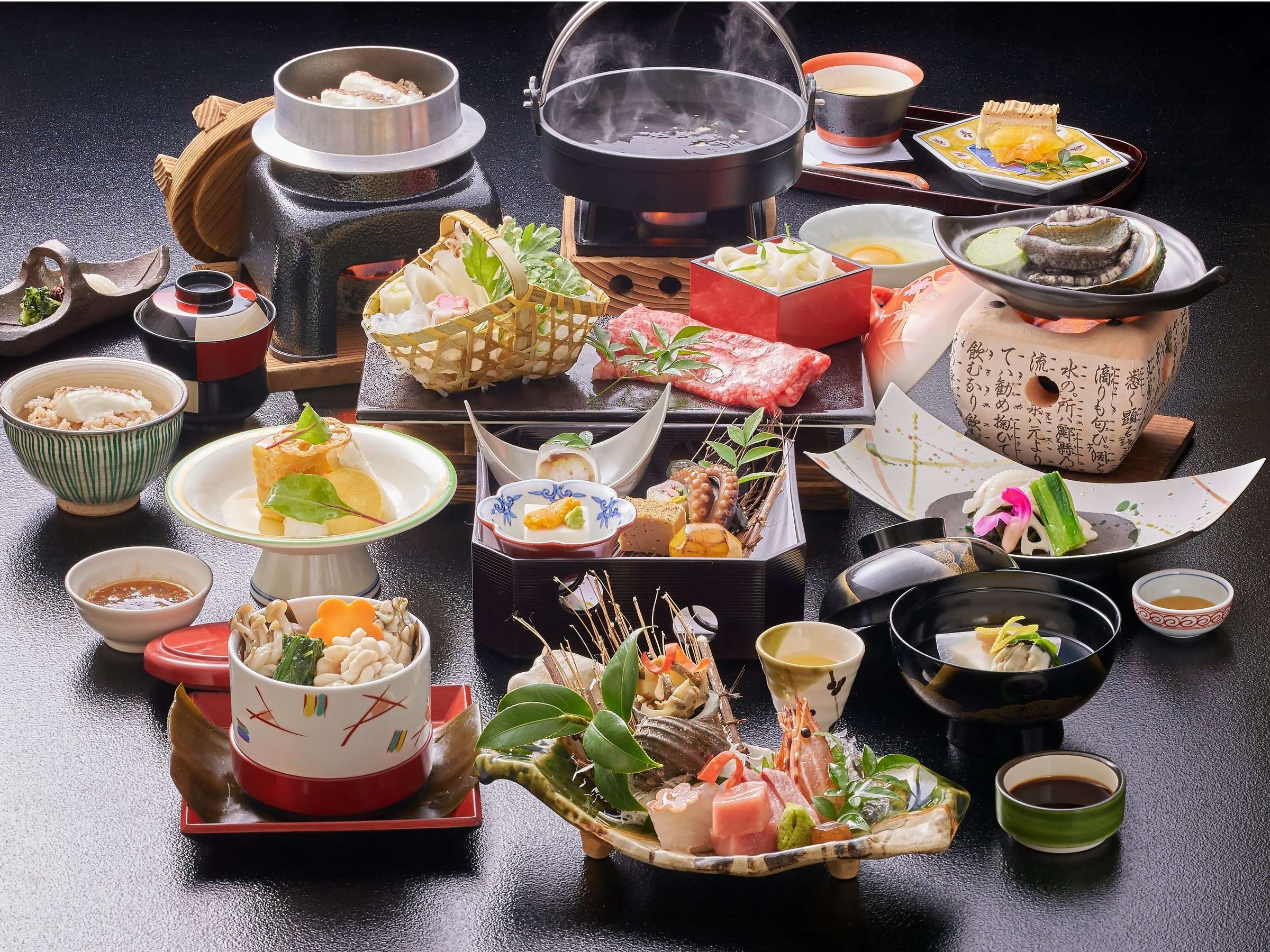 Multi-course kaiseki dinner spread at Hotel Miyarikyu featuring sashimi, hotpot, steamer and seasonal dishes