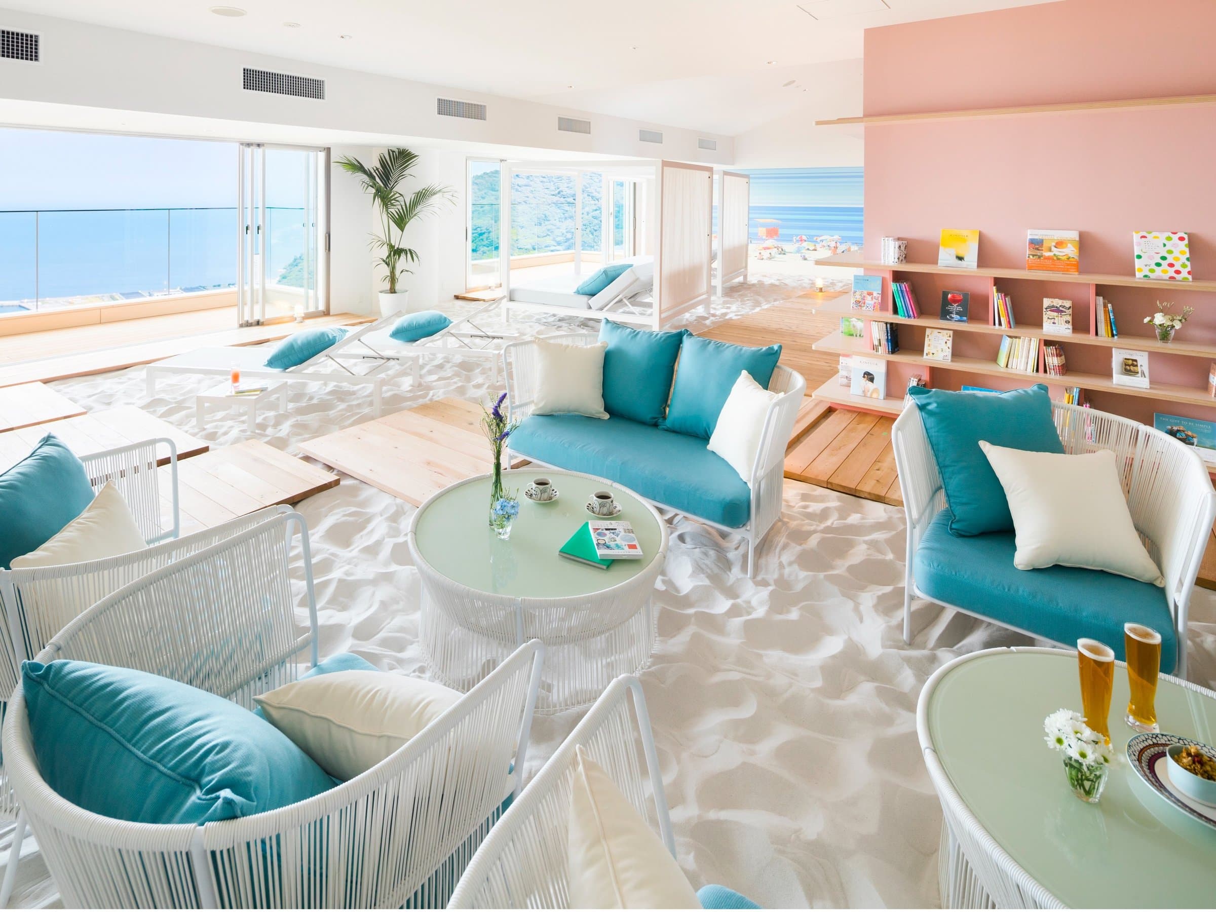 Beach-themed Sola no Books cafe lounge with white sand floor and sea view at Risonare Atami
