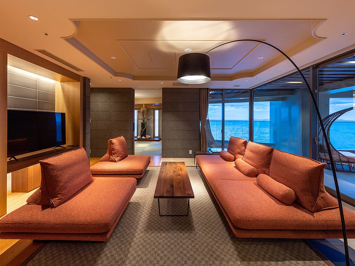 Modern guest room lounge with floor-to-ceiling sea views at Hama no Yu in Izu