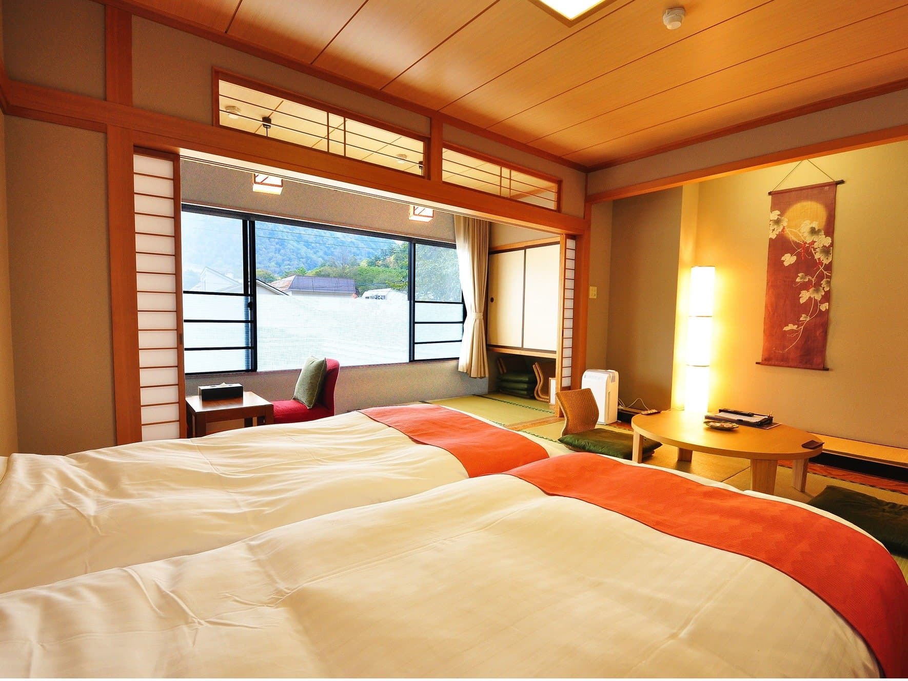 Warm Japanese-style room with twin beds, hanging scroll alcove and mountain view at Yumoto Itaya