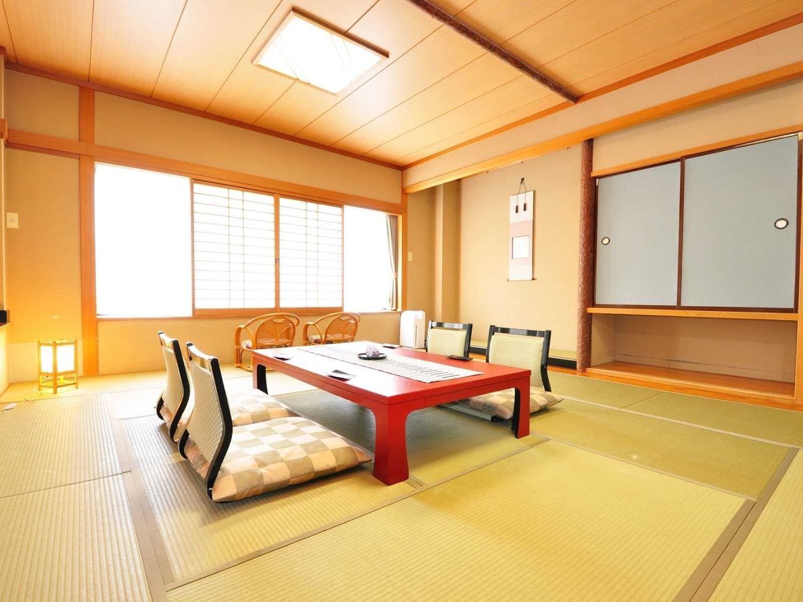 Classic tatami room with red low table and floor chairs at Yumoto Itaya, Okunikko Yumoto Onsen