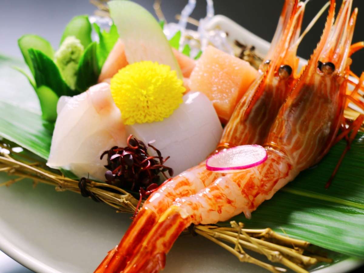 Plated sashimi course of prawn and sliced fish with chrysanthemum garnish from the kaiseki dinner at Oyado Yamashita