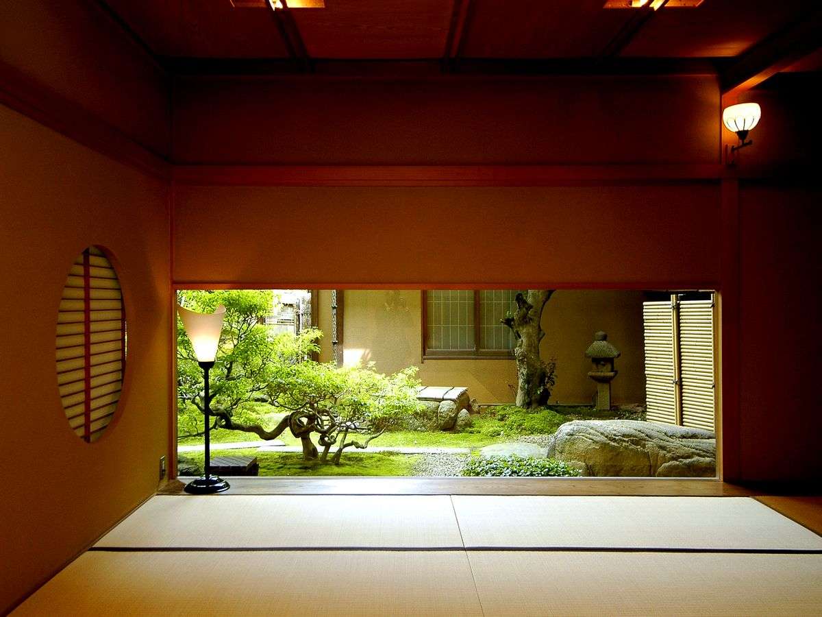 Inner garden viewed through open shoji and timber architecture at Kinjohro ryokan in Kanazawa